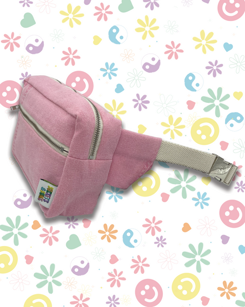 A pink denim waist bag with a zippered front pocket and an adjustable beige webbing strap.