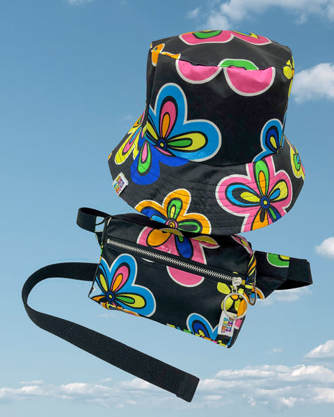 Product shot - black silky bucket hat and matching bumbag with large neon pink and blue flower pattern