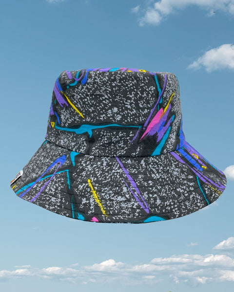 Product shot - black retro 80s bucket hat with streaks of blue, purple and pink all over