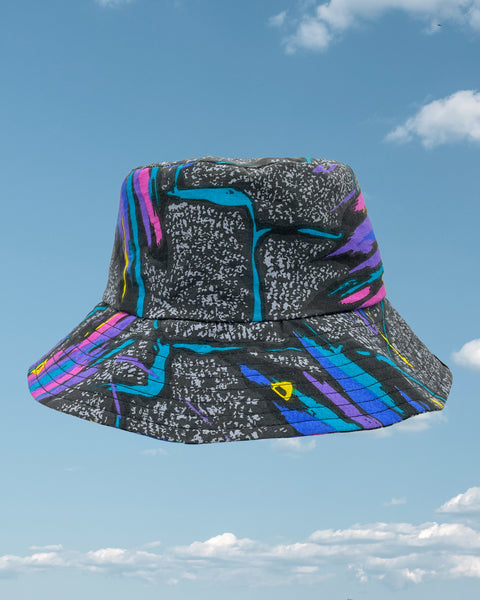 Product shot - black retro 80s bucket hat with streaks of pink, purple and blue all over