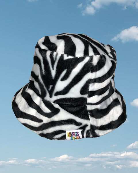 Zebra print faux fur bucket hat showing Buckets & Bums woven label