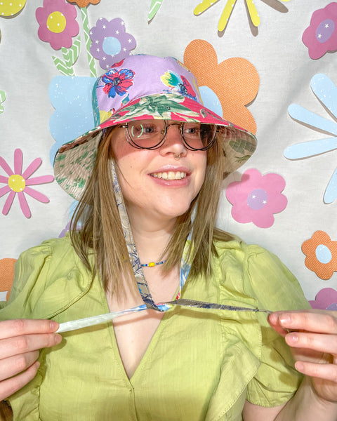 Young woman wearing the fantastic floral mismatched bucket hat 