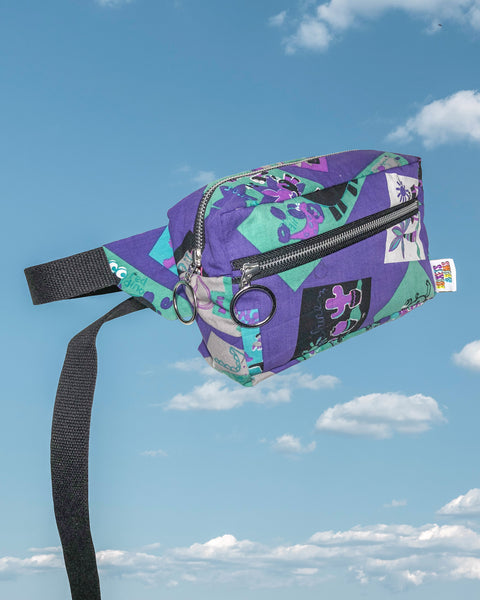 Purple & Teal Dinosaur and Cactus Bumbag. Side profile showing the large round retro zip pulls